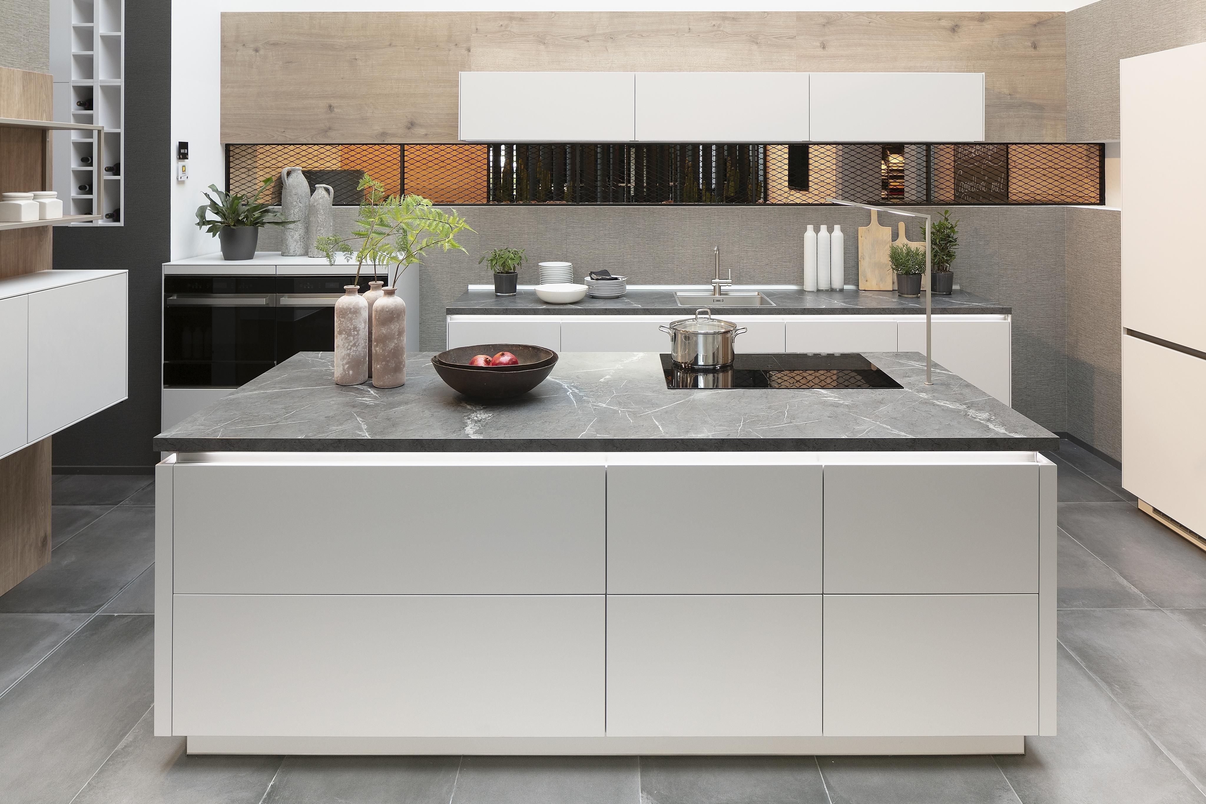 Küche von Artego in Seidengrau mit marmorierter Arbeitsplatte und grifflosen Fronten